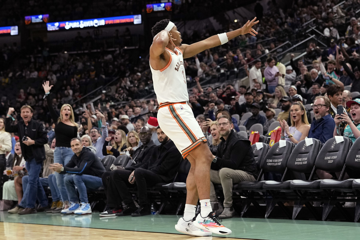 Dec 15, 2023; San Antonio, Texas, USA; San Antonio Spurs forward Keldon Johnson (3) reacts after scoring a three pointer during the first half against the Los Angeles Lakers at Frost Bank Center.