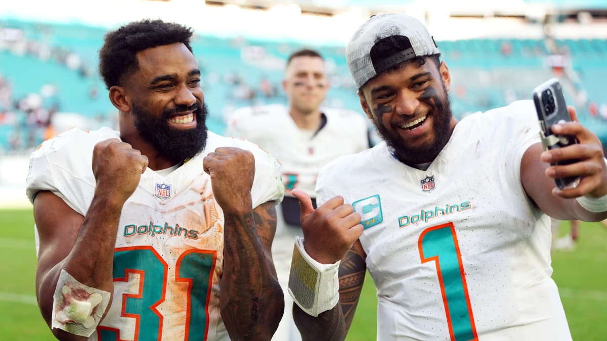 Dolphins running back Raheem Mostert (left) and quarterback Tua Tagovailoa.