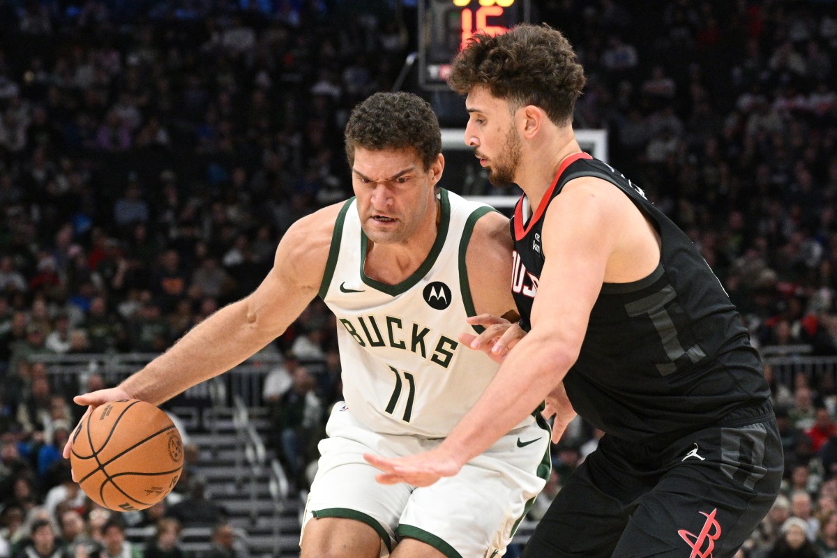 Milwaukee Bucks center Brook Lopez (11) drives against Houston Rockets center Alperen Sengun (28) 