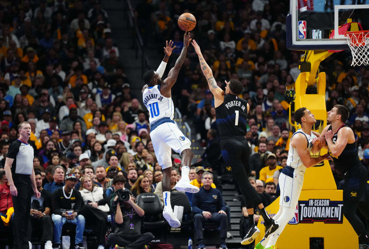 Mavs' Tim Hardaway Jr. shoots a fadeaway jumper over Nuggets' Michael Porter Jr. 