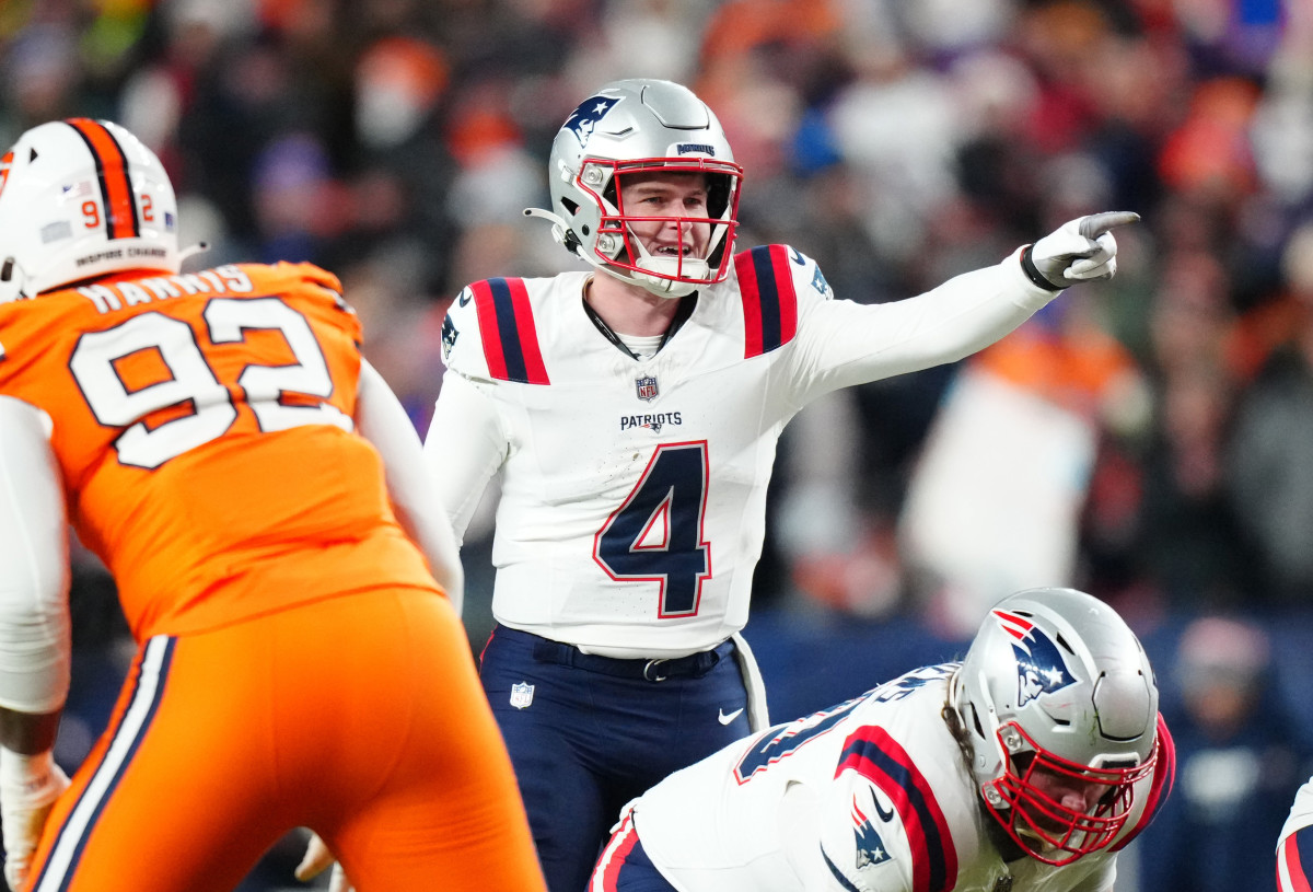 New England Patriots quarterback Bailey Zappe (4) calls out in the first half against the Denver Broncos at Empower Field at Mile High.