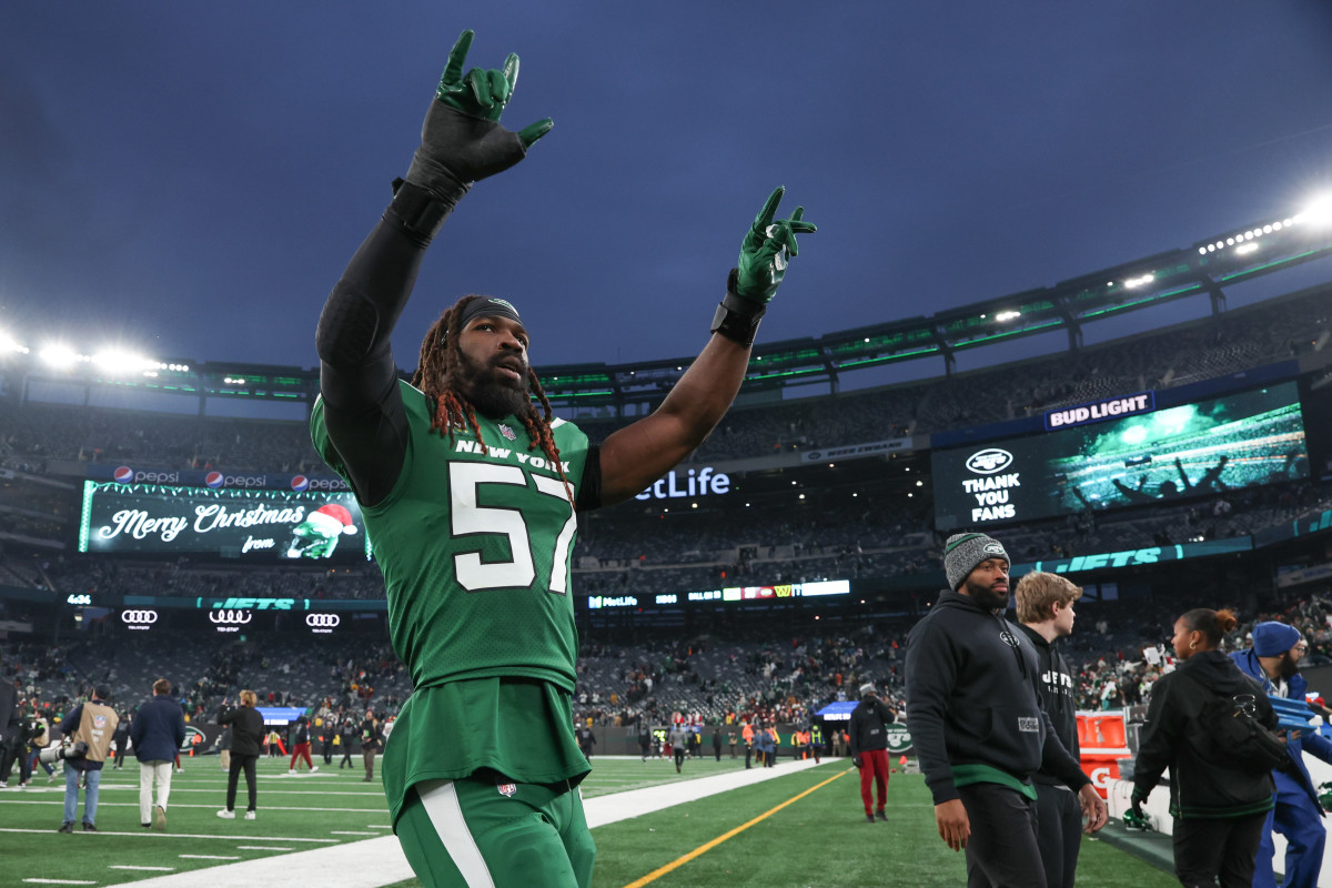 C.J. Mosley walks off the field with both arms up in celebration
