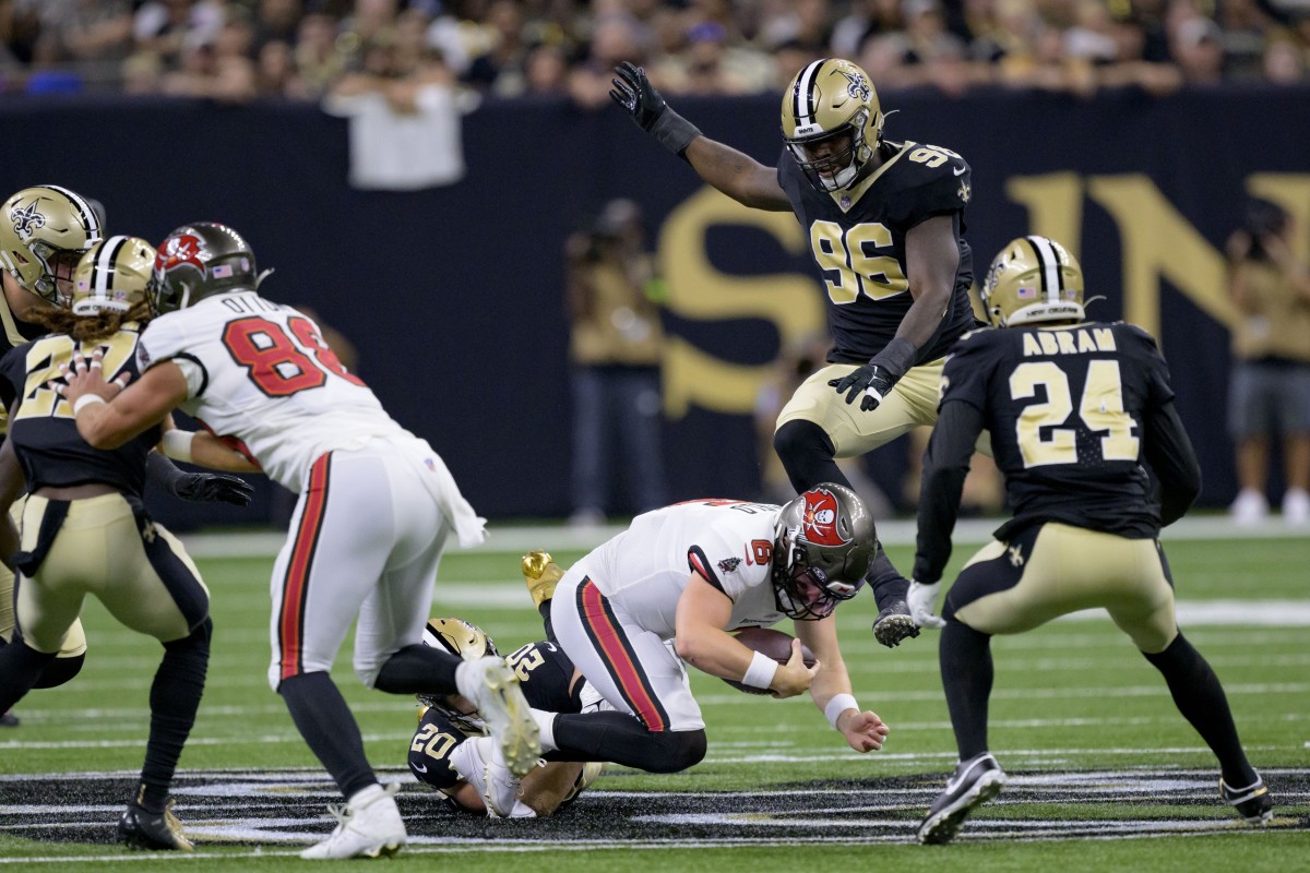 Tampa Bay Buccaneers quarterback Baker Mayfield (6) is brought down by New Orleans Saints linebacker Pete Werner (20) and defensive end Carl Granderson (96). Mandatory Credit: Matthew Hinton-USA TODAY Sports