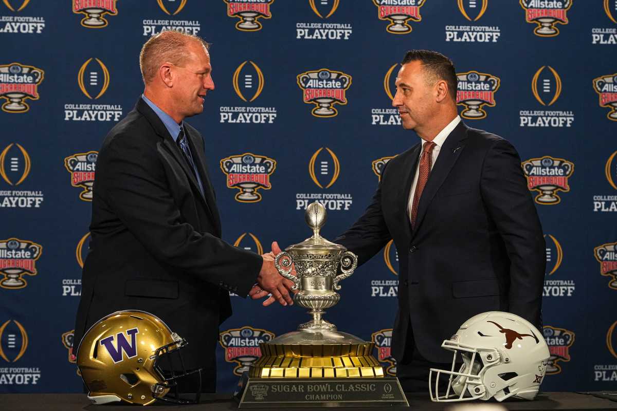 Washinton Huskies head coach Kalen DeBoer, left, meets Texas Longhorns head coach Steve Sarkisian, right, at the head coaches' press conference at the Sheraton hotel on Sunday, Dec. 31, 2023 in New Orleans, Louisiana. The Washington Huskies will take on the Texas longhorns in the College Football Playoff Semi-Finals on January 1, 2024.
