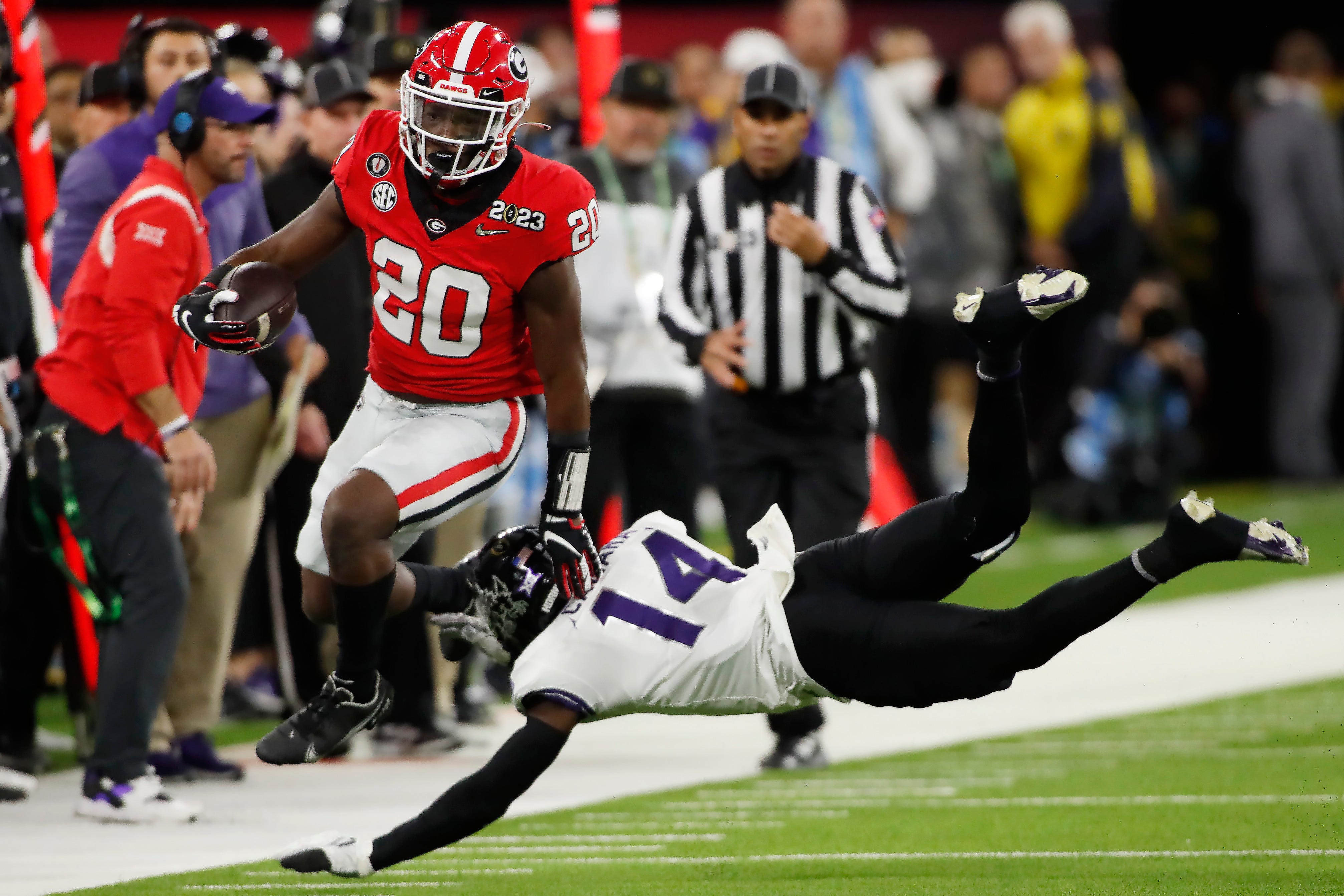 Georgia running back Sevaughn Clark (20) hurdles TCU safety Abraham Camara (14) during the second half of the NCAA College Football National Championship game between TCU and Georgia on Monday, Jan. 9, 2023, in Inglewood, Calif. (Joshua L. Jones / USA TODAY NETWORK).