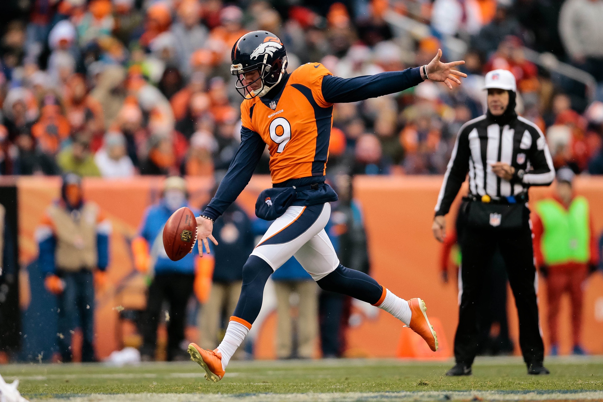 Denver Broncos punter Riley Dixon (9) punts the ball in the first quarter against the Kansas City Chiefs at Sports Authority Field at Mile High.
