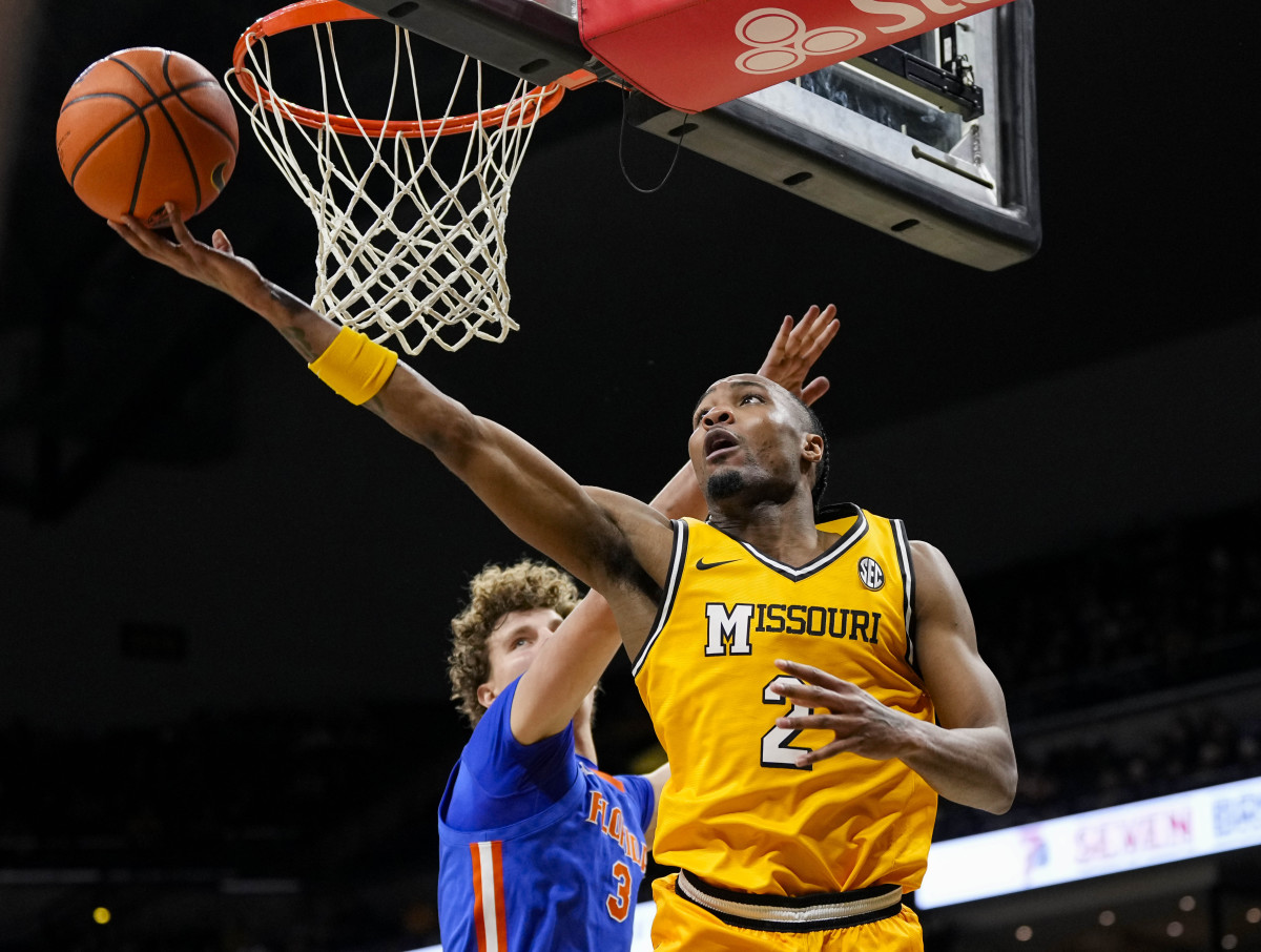 Jan 20, 2024; Columbia, Missouri, USA; Missouri Tigers guard Tamar Bates (2) shoots against Florida Gators center Micah Handlogten (3) during the first half at Mizzou Arena. 